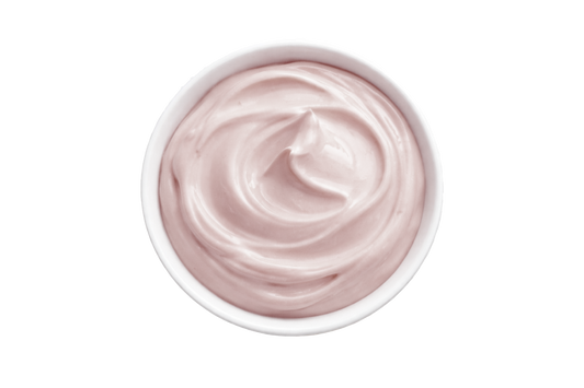 White cream in a small bowl on a white background