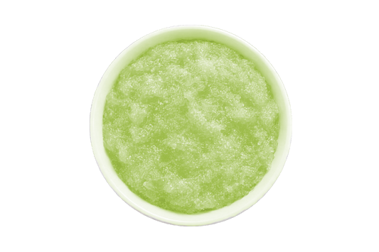 Green smoothie in a white bowl on a white background