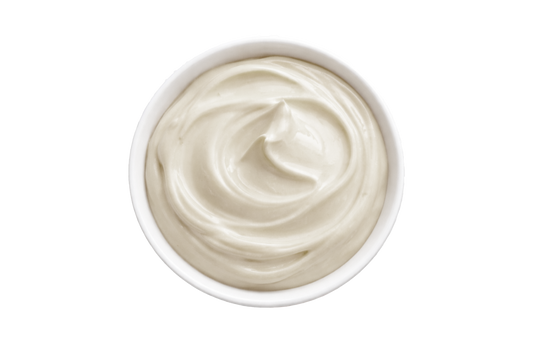 White cream in a small bowl on a white background