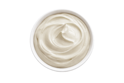 White cream in a small bowl on a white background