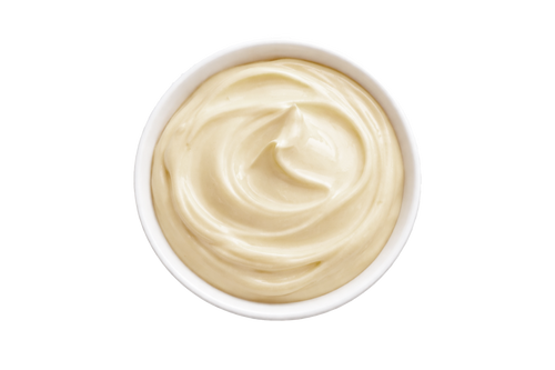 White bowl filled with creamy beige substance on a white background