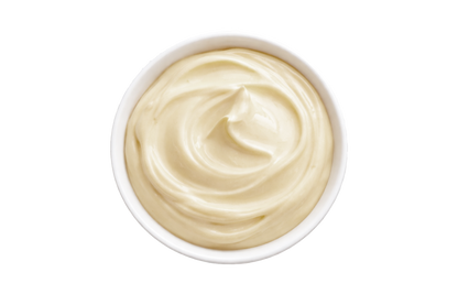 White bowl filled with creamy beige substance on a white background