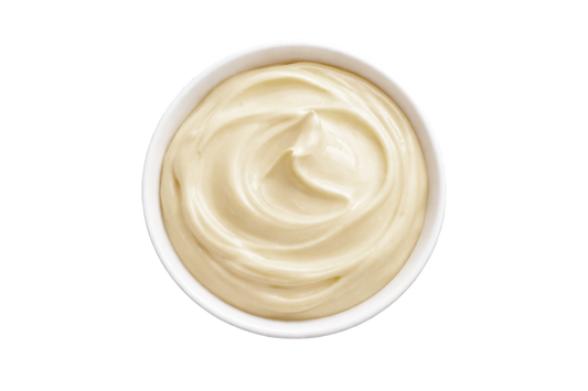 White bowl filled with creamy beige substance on a white background