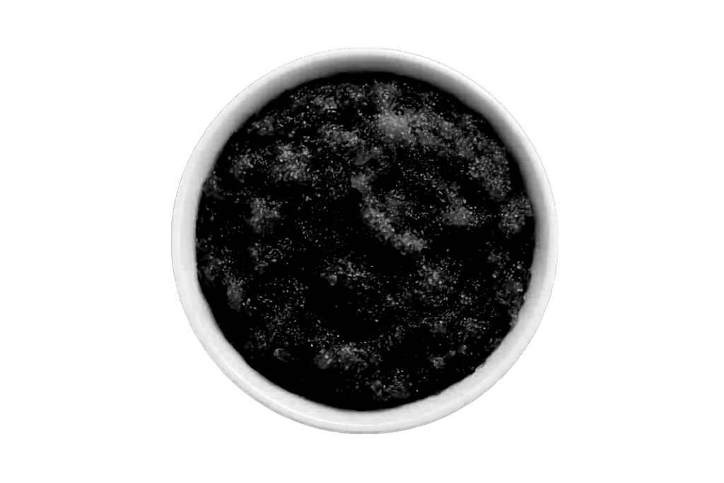 Dark scrub in a white bowl on a white background