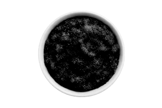Dark scrub in a white bowl on a white background
