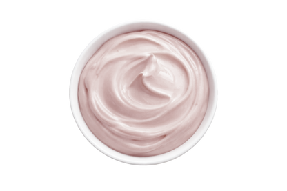 White cream in a small bowl on a white background