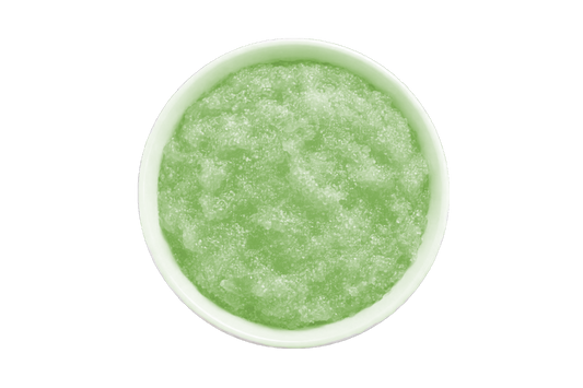 Green smoothie in a white bowl on a white background