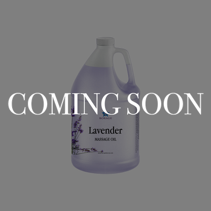 A large plastic jug of lavender massage oil on a gray background with a large white 'COMING SOON' text overlay across the center.