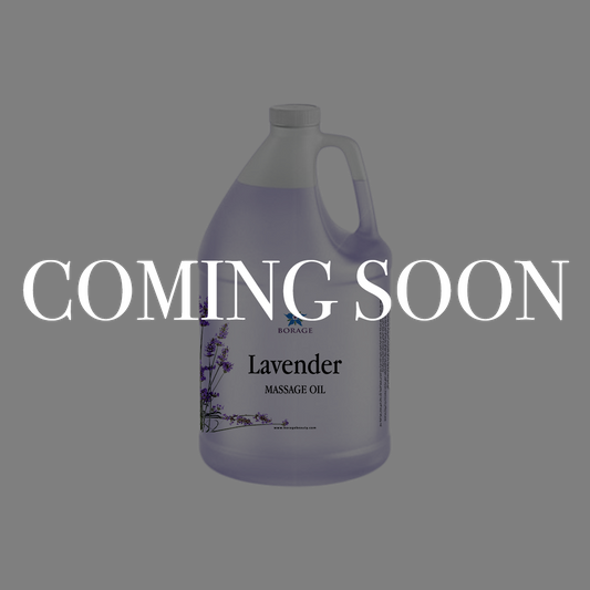 A large plastic jug of lavender massage oil on a gray background with a large white 'COMING SOON' text overlay across the center.