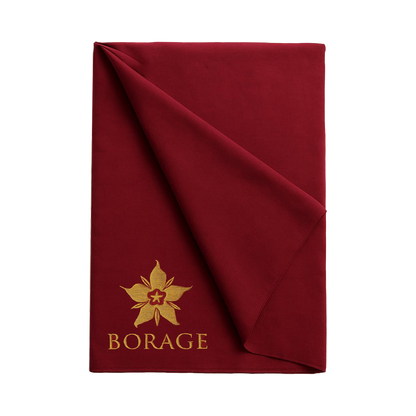 Folded red blanket with gold 'Borage' logo on a white background