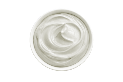 White cream in a small container on a white background