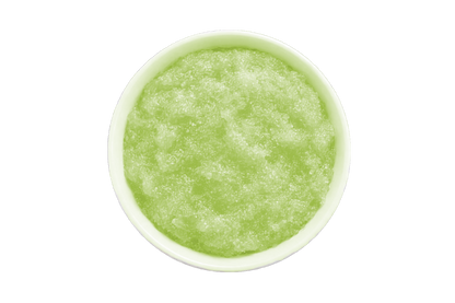 Green smoothie in a white bowl on a white background