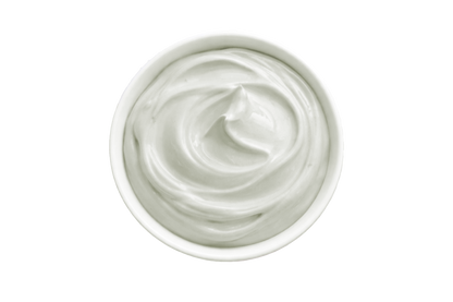 White cream in a small container on a white background